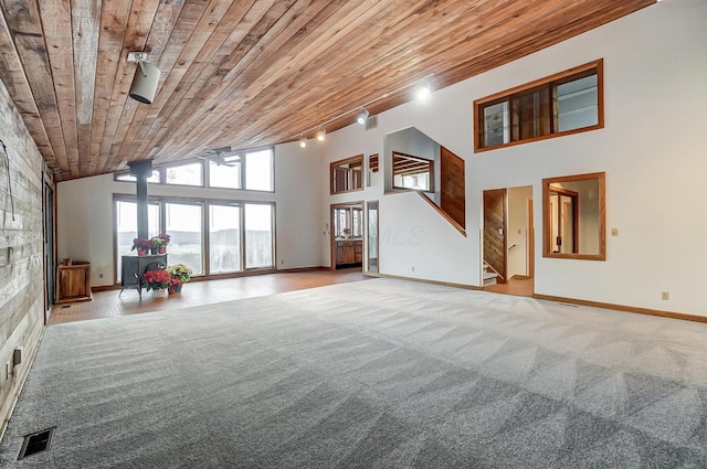 unfurnished living room with carpet flooring, track lighting, high vaulted ceiling, and wooden ceiling