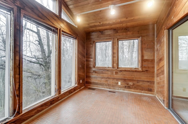 unfurnished sunroom featuring wooden ceiling