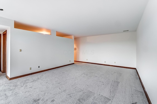 unfurnished room featuring light carpet