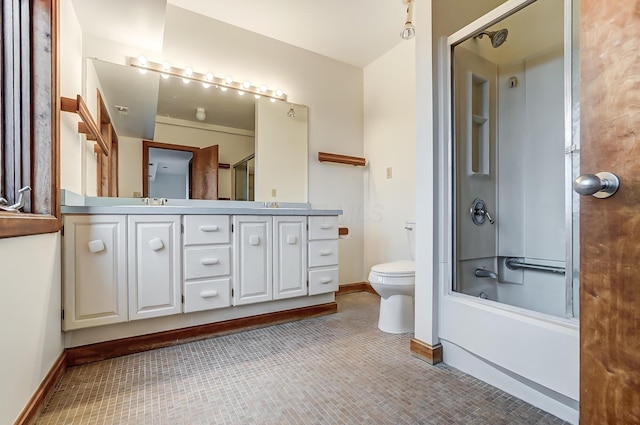 full bathroom with vanity, bath / shower combo with glass door, and toilet