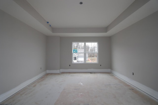 unfurnished room with a raised ceiling