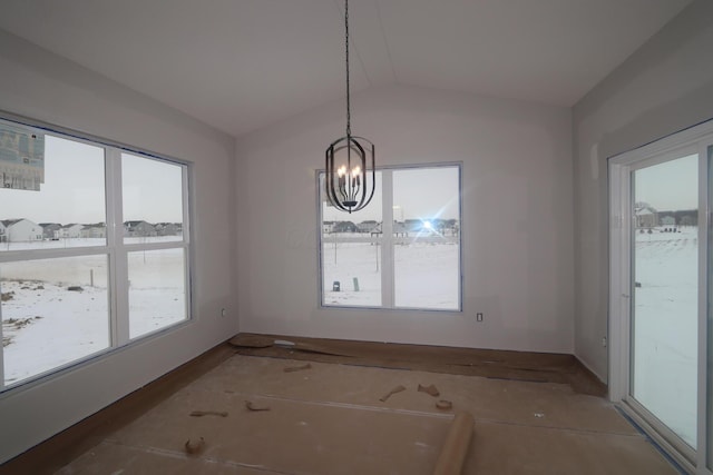 unfurnished dining area featuring vaulted ceiling and a chandelier