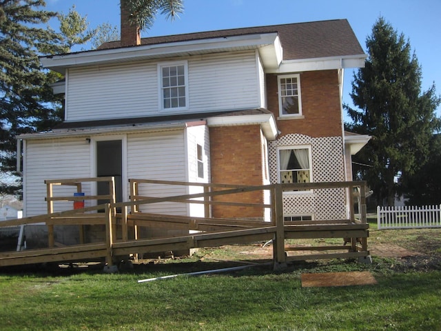 back of property featuring a yard and a deck