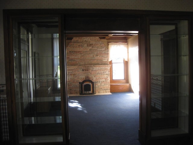 unfurnished living room with a fireplace and carpet floors