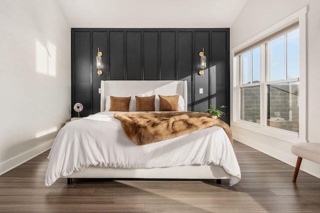 bedroom featuring dark hardwood / wood-style floors and lofted ceiling