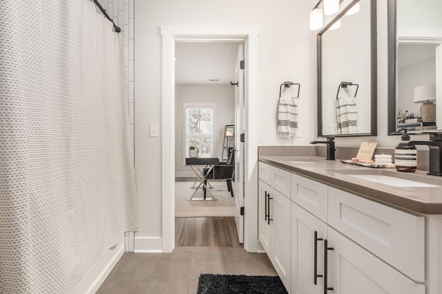 bathroom with tile patterned floors and vanity