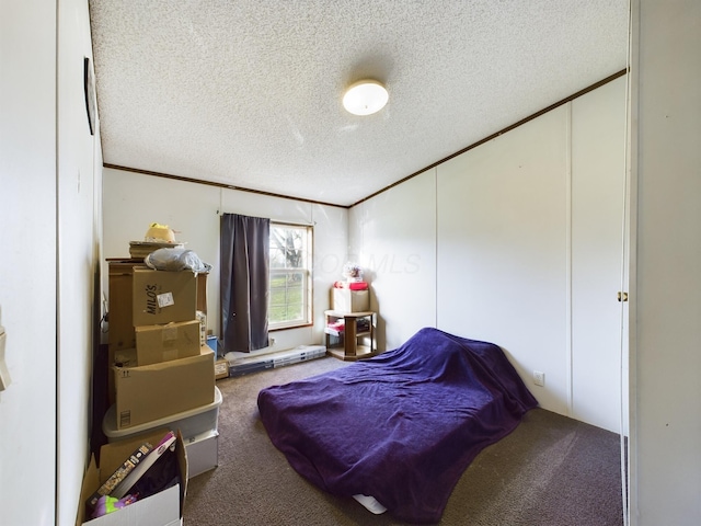 bedroom with carpet floors and a textured ceiling