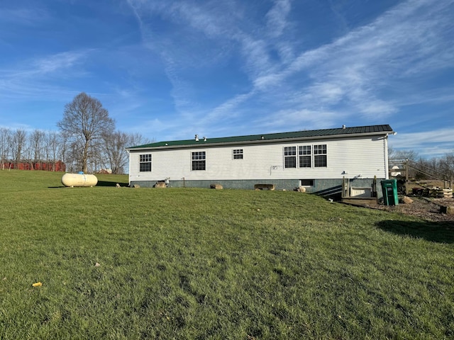 rear view of property with a lawn