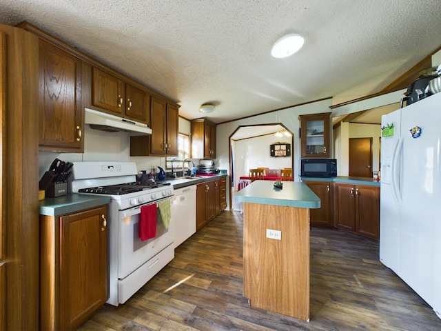 kitchen with white appliances, a center island, dark hardwood / wood-style floors, and sink