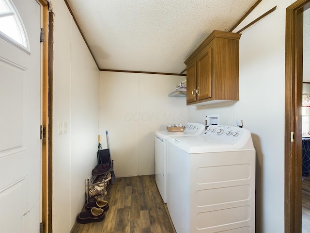 laundry area with a textured ceiling, cabinets, independent washer and dryer, and dark wood-type flooring