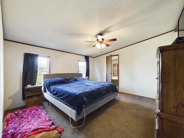 bedroom with ceiling fan, dark carpet, and a textured ceiling