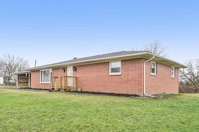 rear view of house featuring a lawn