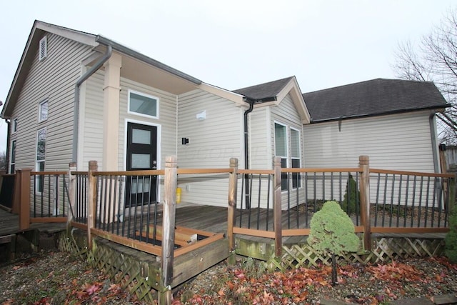 rear view of property featuring a deck