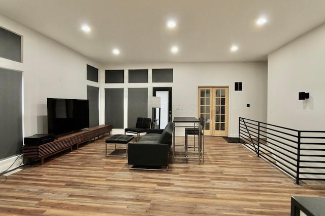 living room featuring french doors and light hardwood / wood-style flooring