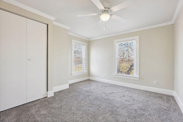 unfurnished bedroom with ceiling fan, a closet, carpet floors, and ornamental molding