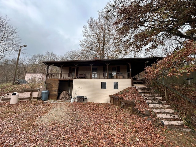 rear view of property featuring a porch