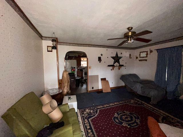 living room featuring ceiling fan and ornamental molding