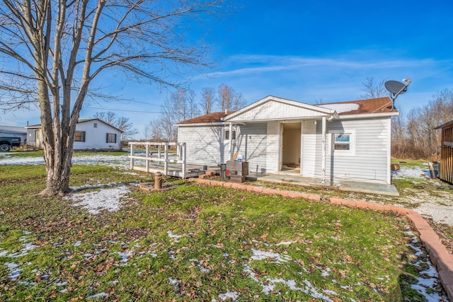 view of front of house featuring a front lawn and a deck