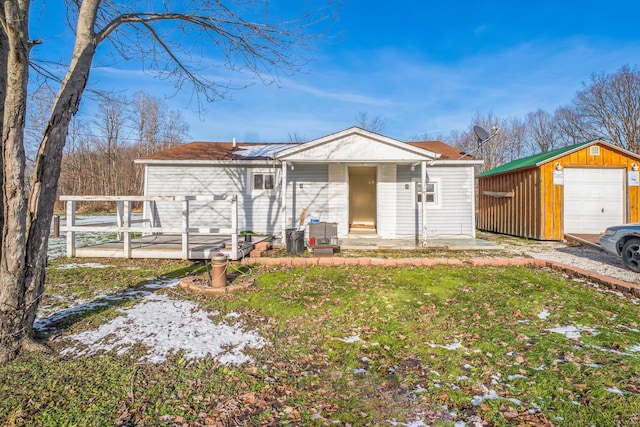 ranch-style house with an outbuilding, a front lawn, a patio, and a garage