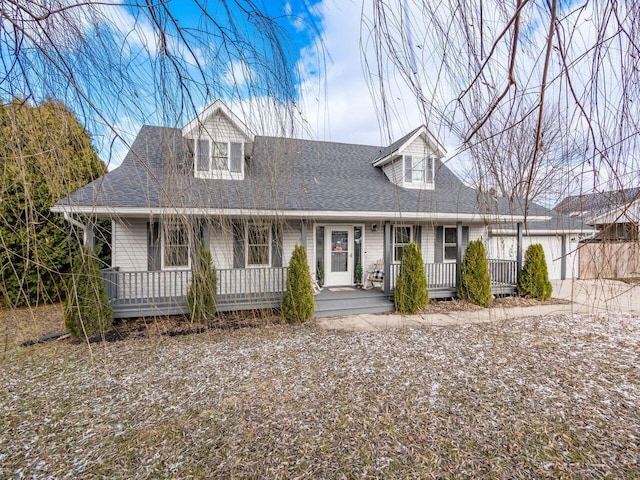 cape cod home with a garage