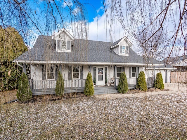 cape cod home featuring a garage