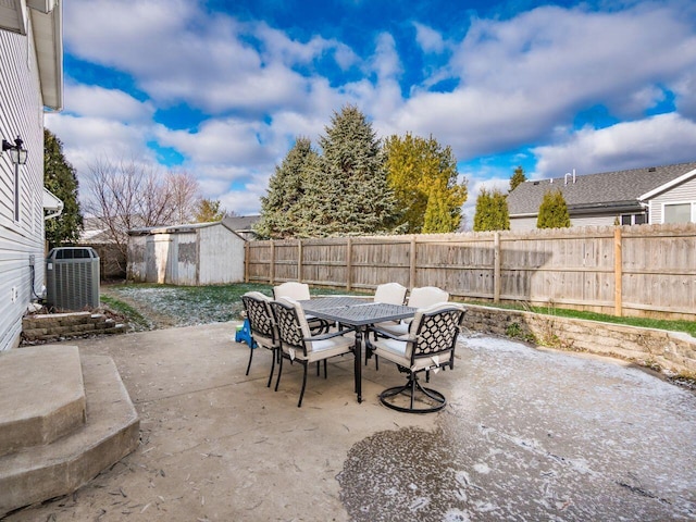 view of patio with central air condition unit and a shed