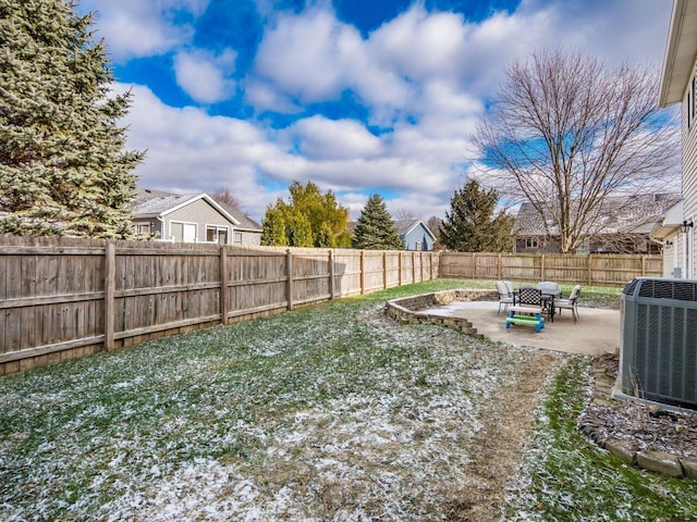 view of yard with central AC unit and a patio