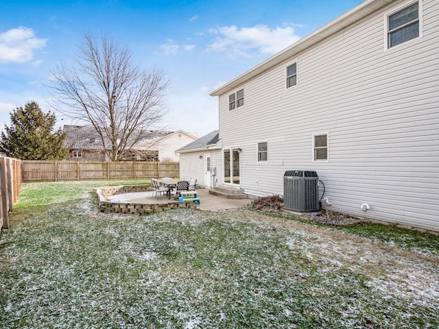 back of house with a patio, central AC, and a lawn