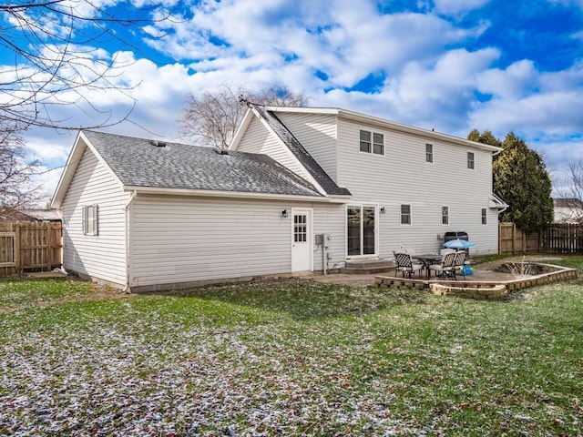 rear view of property featuring a yard and a patio area