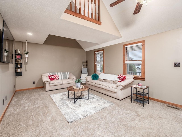 living room featuring carpet, ceiling fan, a textured ceiling, and high vaulted ceiling