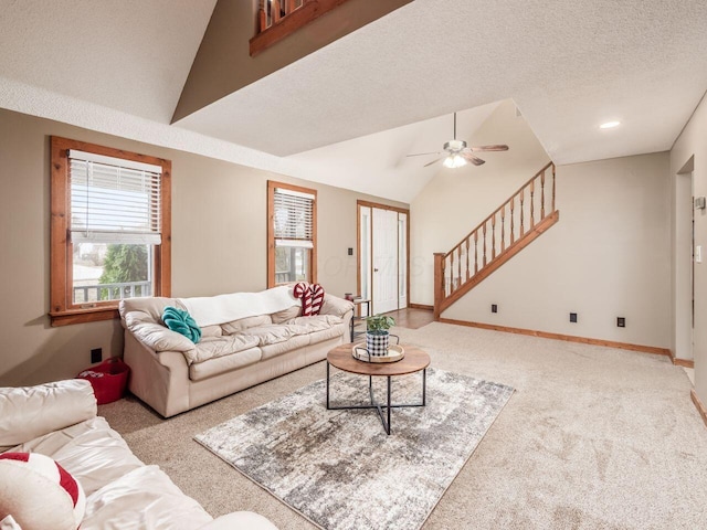 carpeted living room featuring ceiling fan, a textured ceiling, and vaulted ceiling