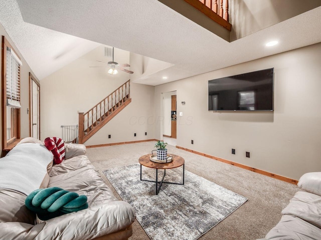 living room featuring carpet, a textured ceiling, and ceiling fan