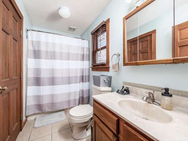 bathroom featuring vanity, tile patterned floors, toilet, a textured ceiling, and curtained shower