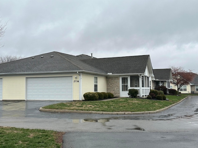 view of side of home with a yard and a garage