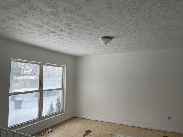 empty room with a textured ceiling