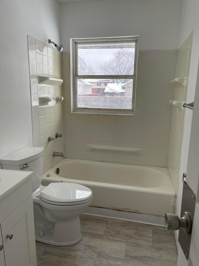 full bathroom with vanity, toilet, and tiled shower / bath