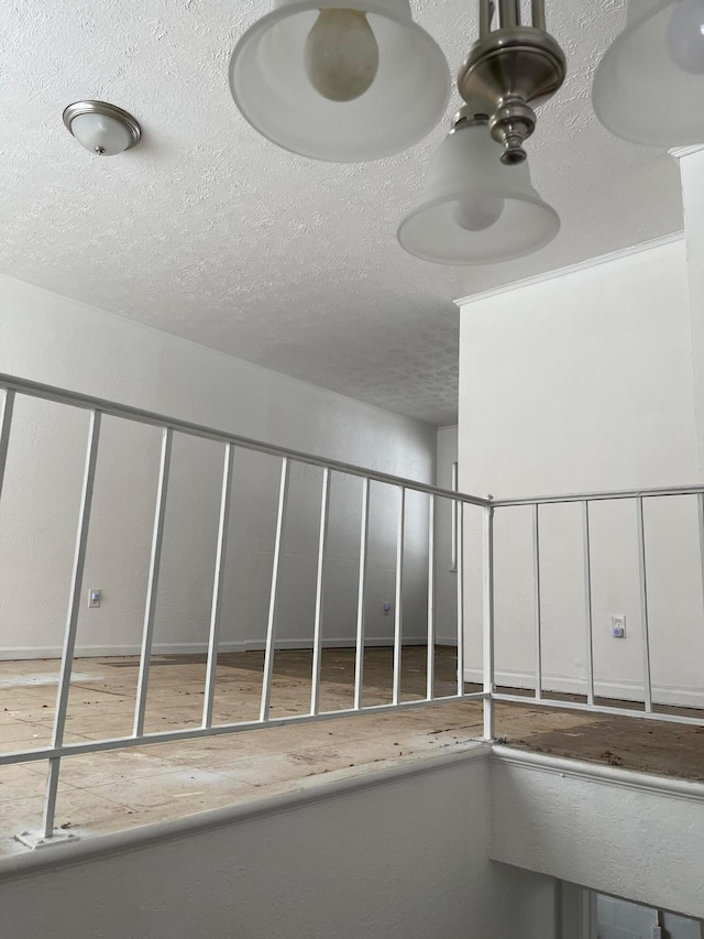 interior space with ceiling fan and a textured ceiling