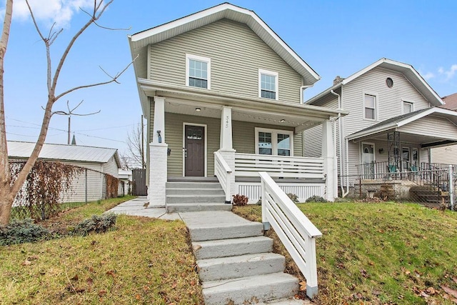 view of front of property with a porch and a front lawn