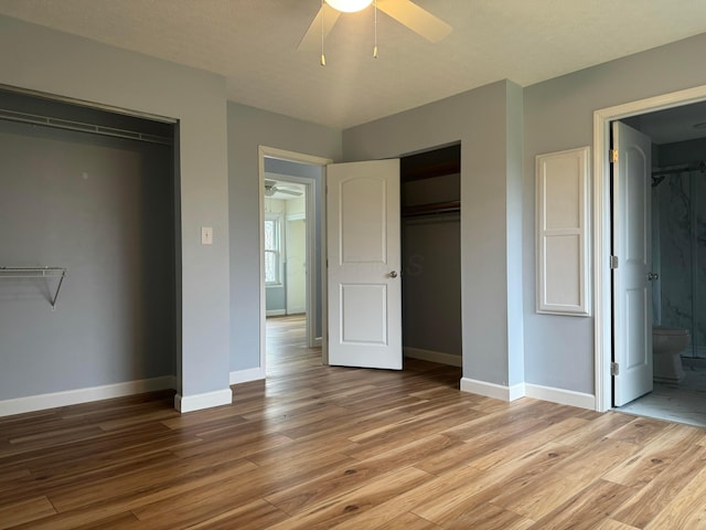 unfurnished bedroom featuring connected bathroom, ceiling fan, light hardwood / wood-style flooring, and a textured ceiling