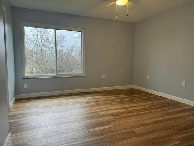 spare room featuring ceiling fan and light wood-type flooring