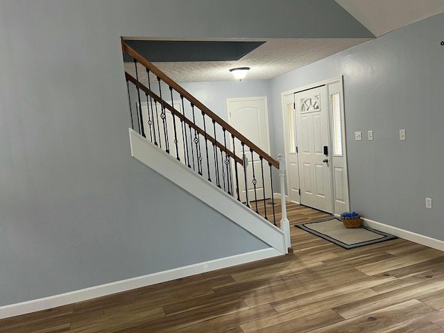 entrance foyer with a textured ceiling and hardwood / wood-style flooring