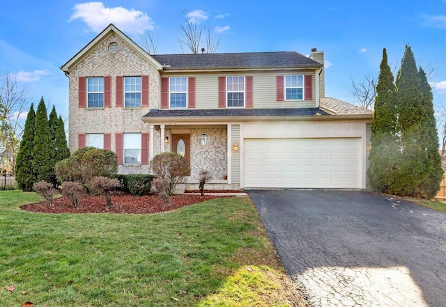 view of front of home featuring a front lawn and a garage