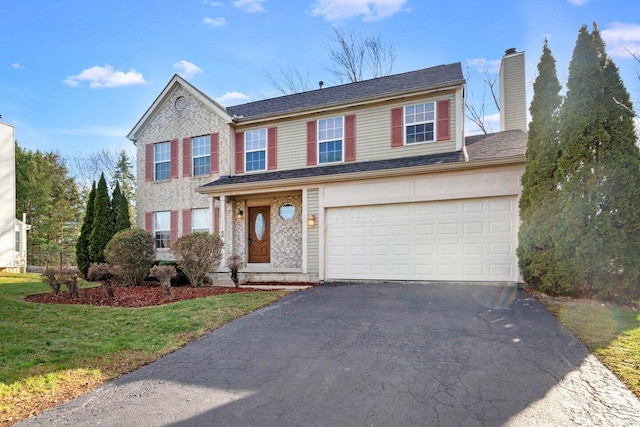 view of front of property with a garage and a front lawn