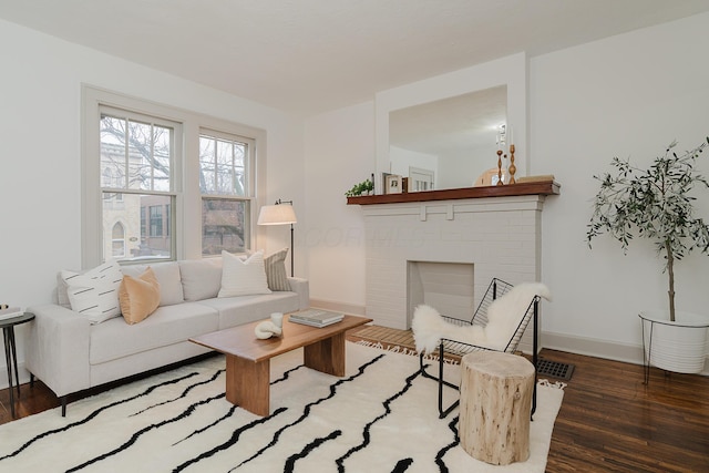 living room featuring hardwood / wood-style flooring and a fireplace