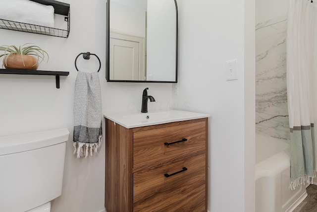 full bathroom featuring hardwood / wood-style flooring, vanity, toilet, and tub / shower combination