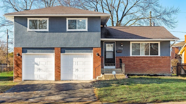 split level home with a front yard and a garage