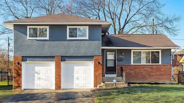 split level home featuring a front yard and a garage