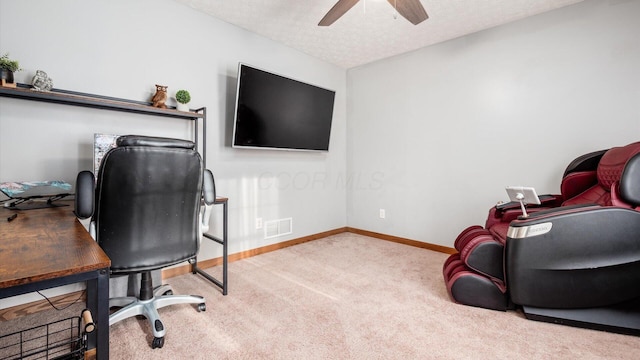 carpeted office featuring ceiling fan and a textured ceiling