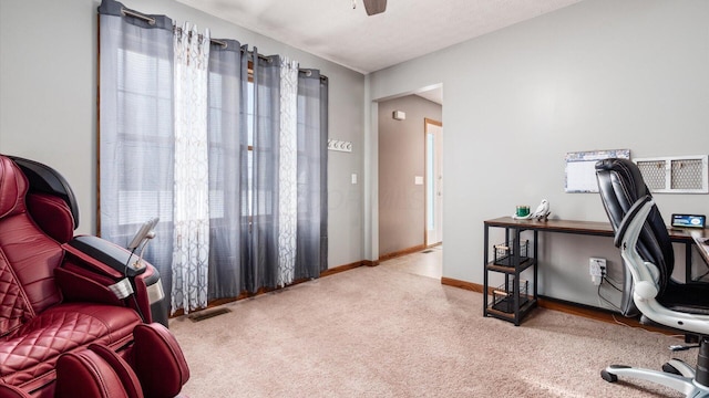 carpeted office space with ceiling fan