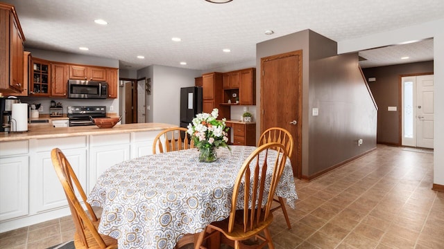 dining space featuring a textured ceiling